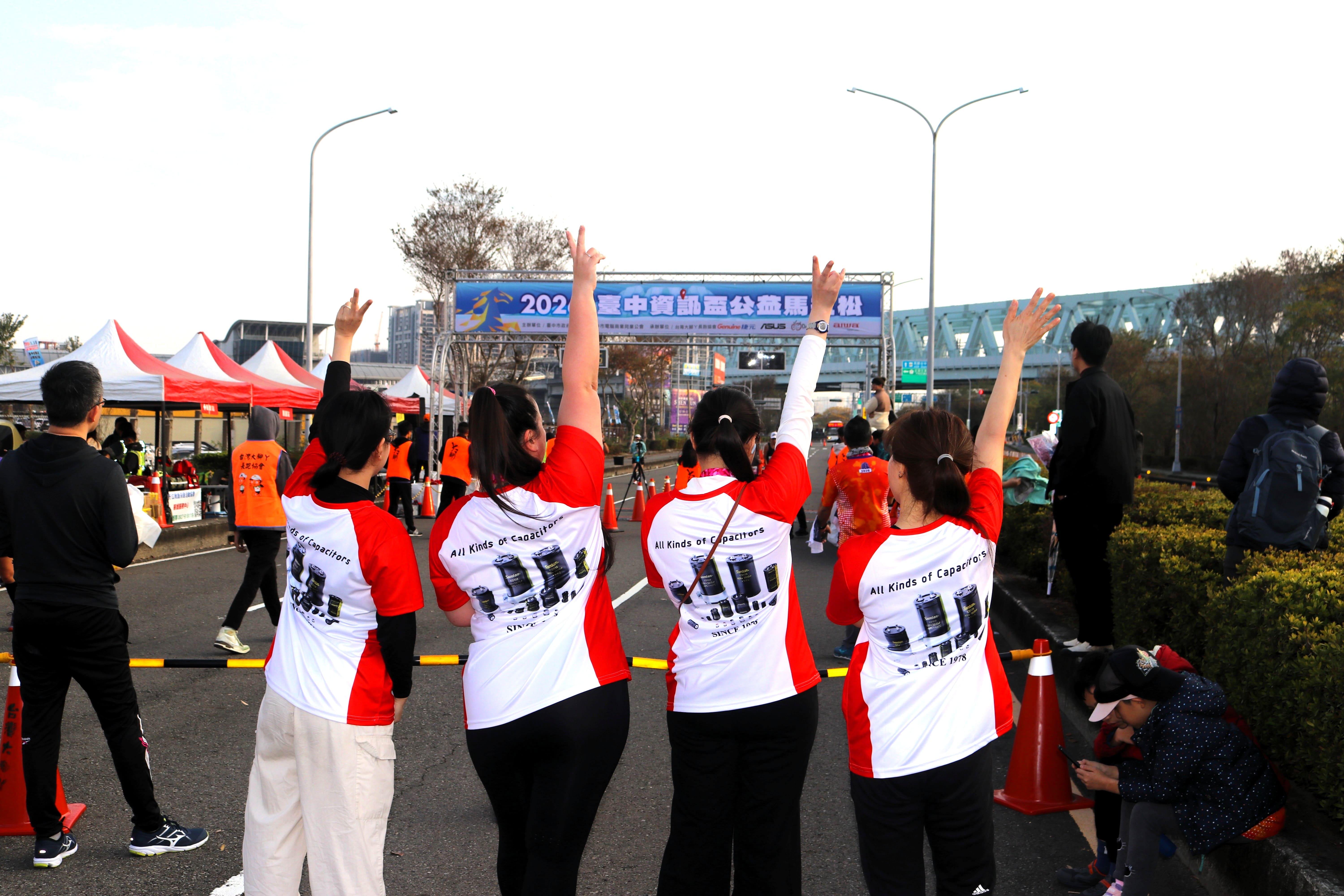 Suntan corporate team cheering at marathon event